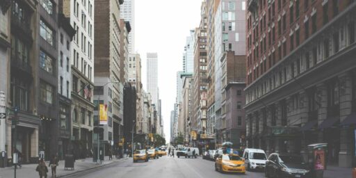 high-resolution photo of pedestrian, architecture, road, street, town, alley, city, urban, cityscape, downtown, taxi, cab, intersection, crosswalk, lane, publicdomain, automobiles, skyscrapers, pedestrians, buildings, windows, americanflag, infrastructure, neighbourhood, road surface, residential area, human settlement, metropolitan area, nonbuilding structure